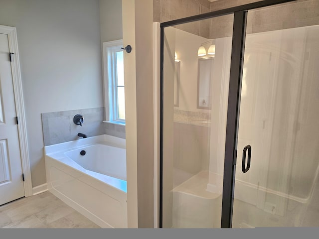 bathroom with a garden tub and a shower stall