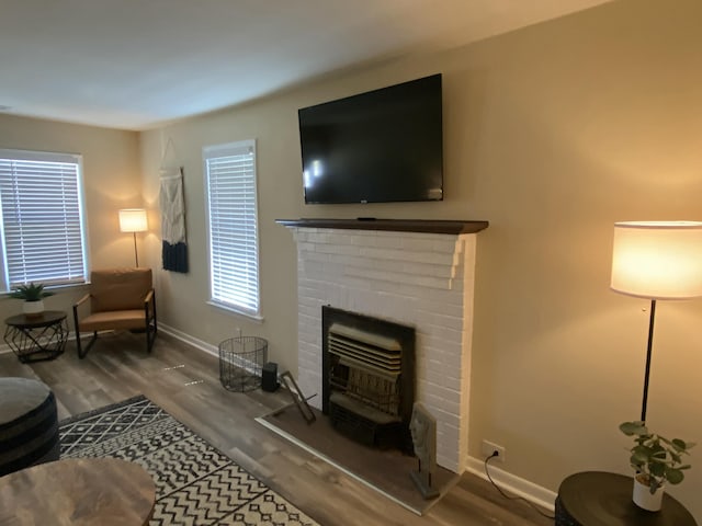 living room with hardwood / wood-style floors and a fireplace