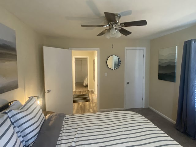 bedroom featuring dark carpet and ceiling fan