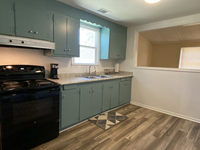 kitchen featuring black electric range oven, sink, dark hardwood / wood-style floors, and green cabinetry