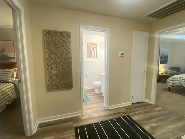 bathroom with hardwood / wood-style flooring and toilet