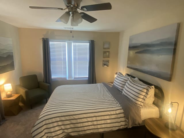 carpeted bedroom with ceiling fan