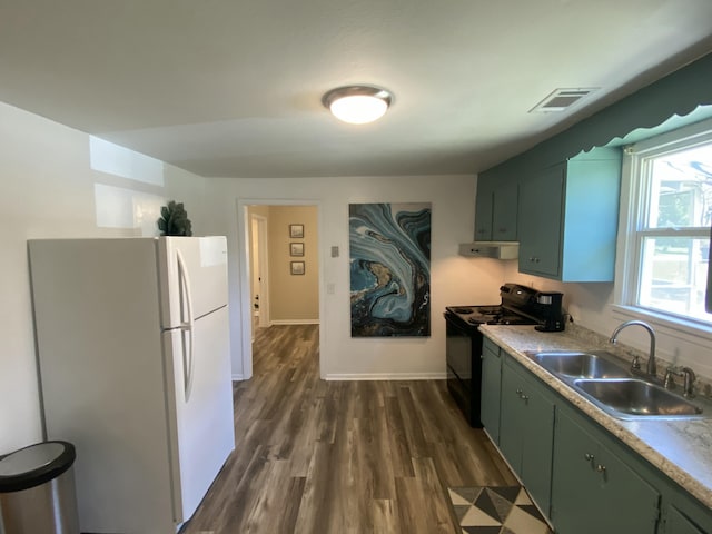 kitchen featuring sink, dark hardwood / wood-style floors, white refrigerator, black electric range, and green cabinetry