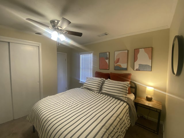 bedroom featuring ornamental molding, ceiling fan, and a closet