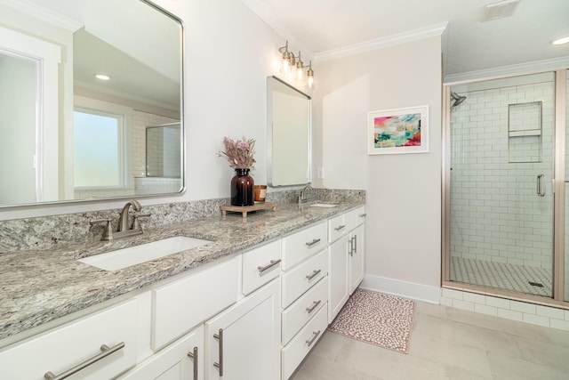 bathroom featuring crown molding, a sink, and a shower stall