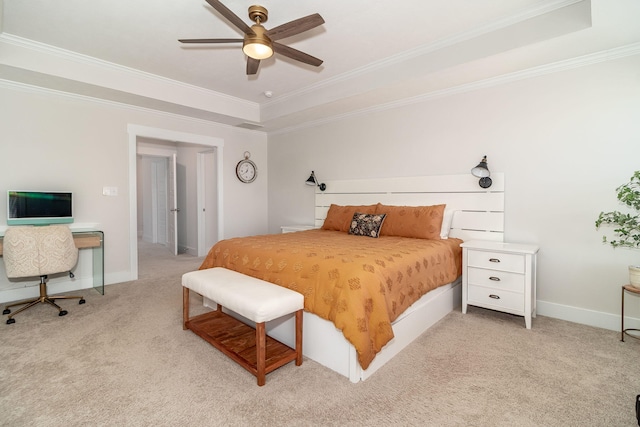 bedroom with baseboards, a tray ceiling, ornamental molding, and light colored carpet