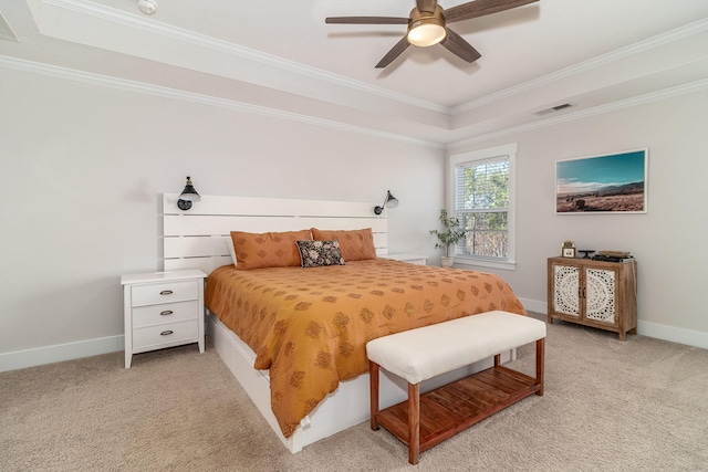 bedroom with light carpet, visible vents, baseboards, ornamental molding, and a tray ceiling