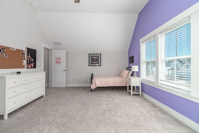 bedroom featuring light colored carpet, vaulted ceiling, and baseboards