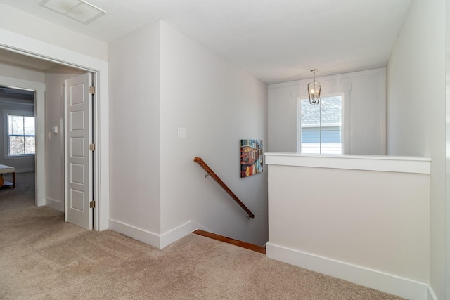 stairs with baseboards, carpet flooring, visible vents, and a healthy amount of sunlight