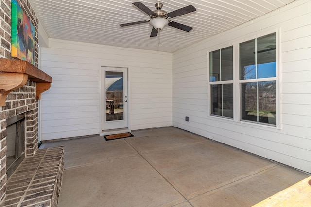 view of patio / terrace featuring ceiling fan and an outdoor brick fireplace