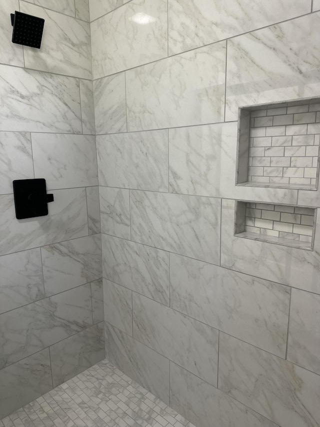 bathroom with a tile shower