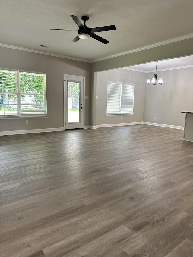 unfurnished room featuring dark wood-type flooring, ceiling fan with notable chandelier, and ornamental molding