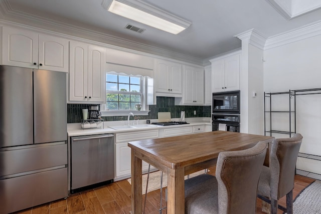 3489 Evans To Locks Rd, Martinez, GA 30907 - kitchen with black appliances, white cabinetry, light countertops, decorative backsplash, and ornamental molding