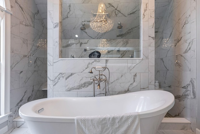 3489 Evans To Locks Rd, Martinez, GA 30907 - bathroom with marble look tile flooring, a soaking tub, tile walls, and a chandelier