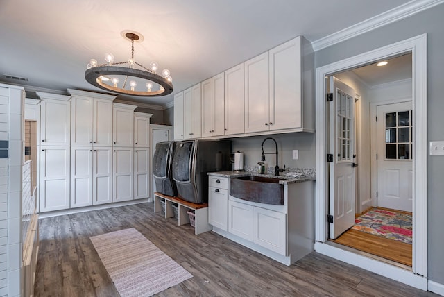 3489 Evans To Locks Rd, Martinez, GA 30907 - laundry room featuring separate washer and dryer, ornamental molding, a chandelier, and dark wood-type flooring