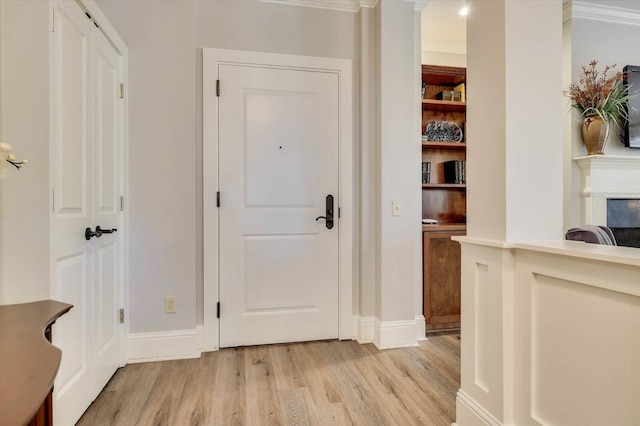 hall featuring crown molding and light hardwood / wood-style floors