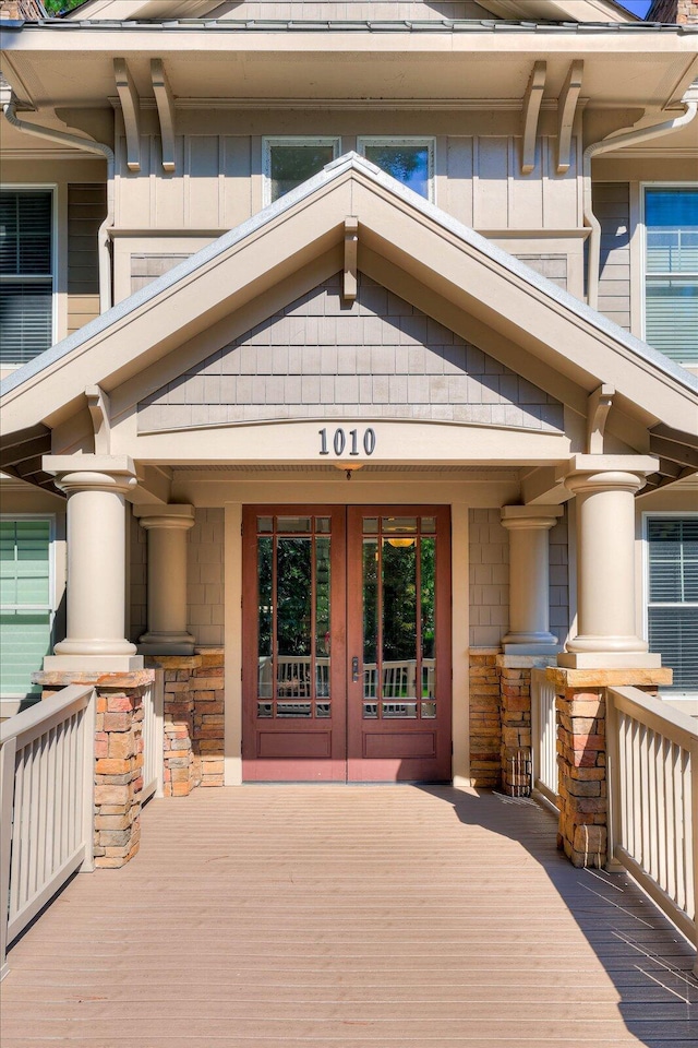 doorway to property with a porch and french doors