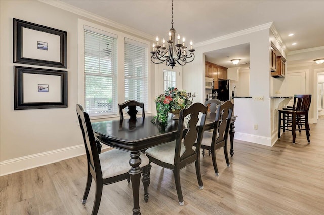 dining space with light wood-type flooring, crown molding, and a chandelier