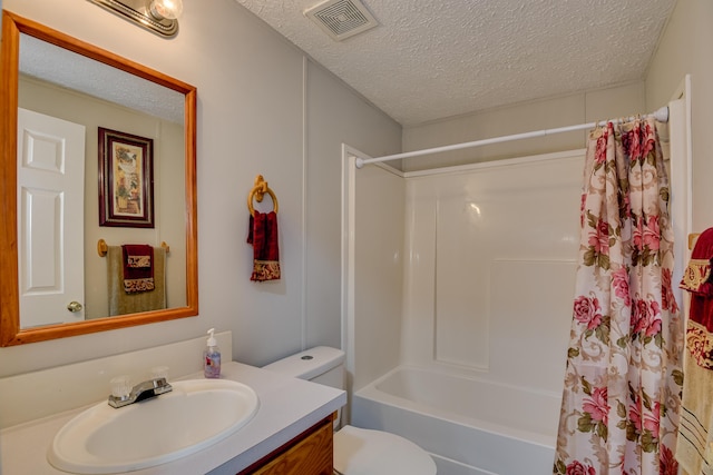 full bathroom featuring vanity, shower / bath combination with curtain, toilet, and a textured ceiling