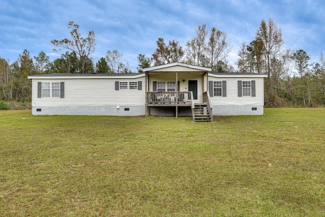 back of house with covered porch and a yard