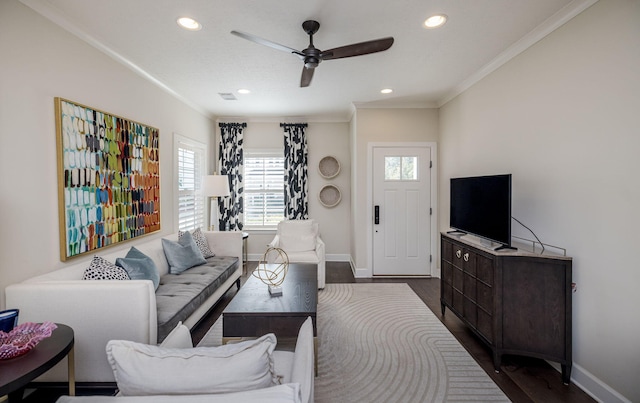 living room with crown molding, dark hardwood / wood-style flooring, and ceiling fan