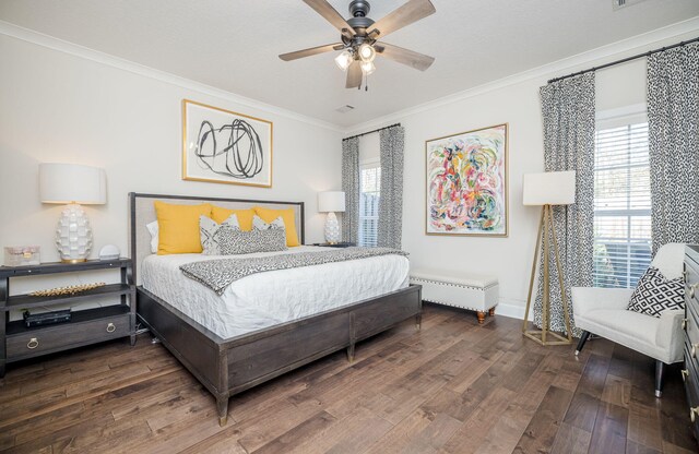 bedroom with ceiling fan, dark hardwood / wood-style floors, and ornamental molding