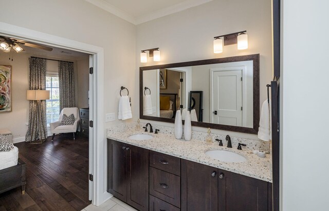 bathroom featuring hardwood / wood-style floors, vanity, ceiling fan, and crown molding