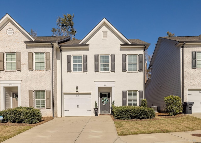 view of front of property with a garage and central air condition unit