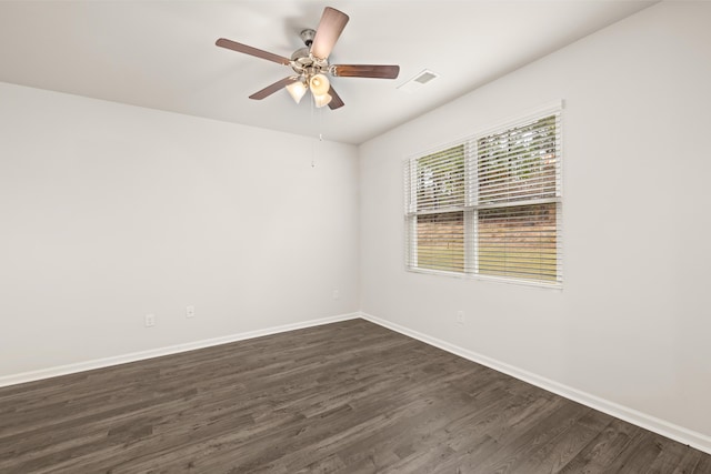 empty room featuring dark wood-type flooring and ceiling fan