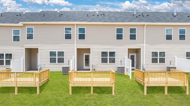 rear view of property featuring a deck and a yard