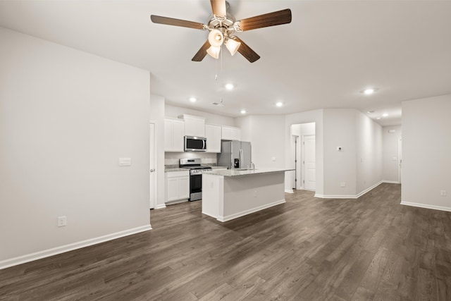 kitchen featuring a kitchen island with sink, dark hardwood / wood-style flooring, white cabinets, appliances with stainless steel finishes, and ceiling fan