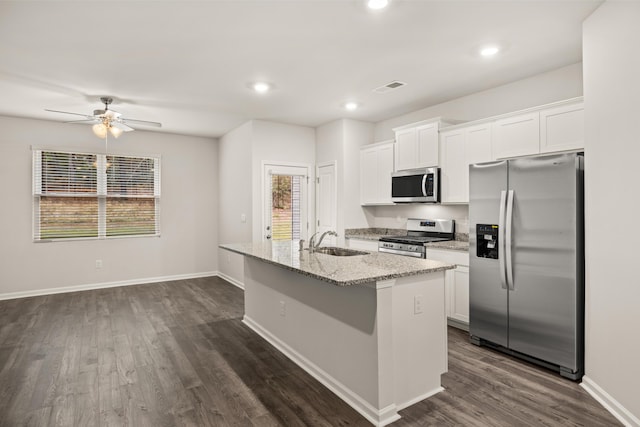 kitchen with white cabinets, stainless steel appliances, a kitchen island with sink, and sink