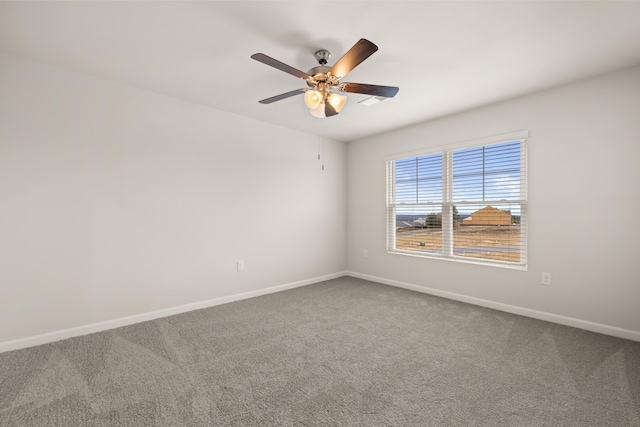 spare room featuring ceiling fan and carpet floors