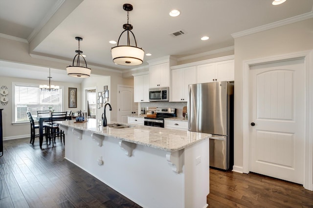 1391 Ackerman Dr, Graniteville, SC 29829 - kitchen featuring appliances with stainless steel finishes, a sink, a kitchen bar, white cabinets, and recessed lighting