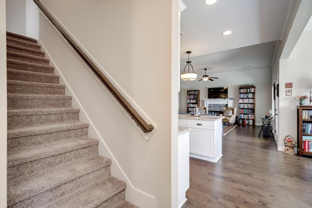 1391 Ackerman Dr, Graniteville, SC 29829 - stairway featuring a ceiling fan, a fireplace, wood finished floors, recessed lighting, and baseboards