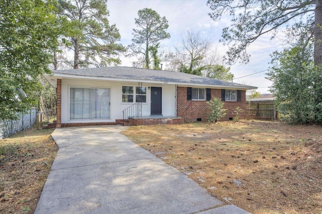 ranch-style house with crawl space, driveway, brick siding, and fence