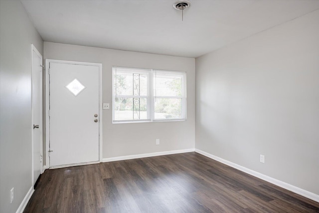 entryway featuring visible vents, baseboards, and dark wood-style floors