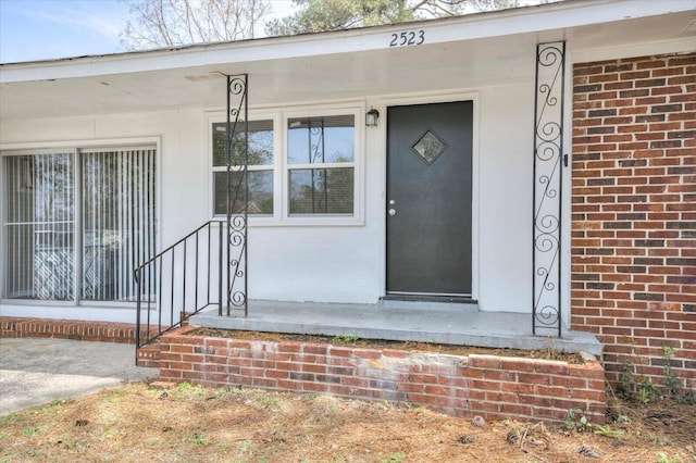 property entrance with brick siding