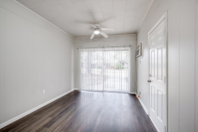 empty room with baseboards, ceiling fan, dark wood-style flooring, and crown molding