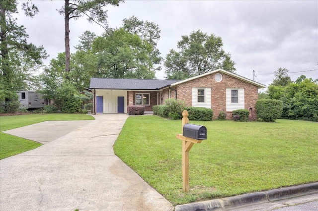 1702 Forest Creek Rd, Augusta, GA 30909 - single story home featuring brick siding, driveway, a front yard, an attached carport, and board and batten siding