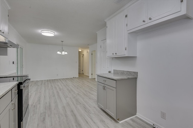 4102 Sapling Ln, Augusta, GA 30906 - kitchen with stainless steel range with electric cooktop, a chandelier, light wood-style floors, baseboards, and a textured ceiling