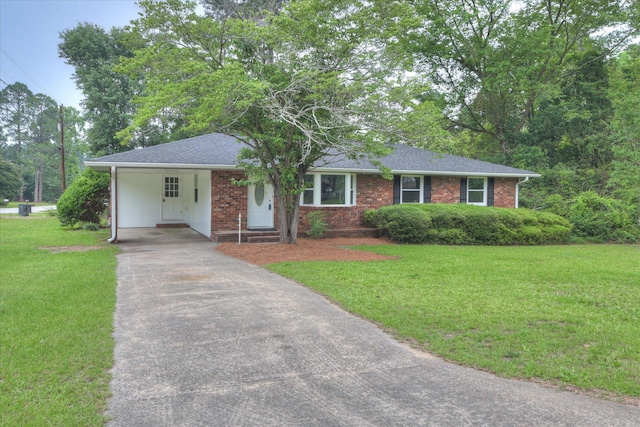 4102 Sapling Ln, Augusta, GA 30906 - ranch-style house with a front lawn, driveway, a carport, brick siding, and roof with shingles