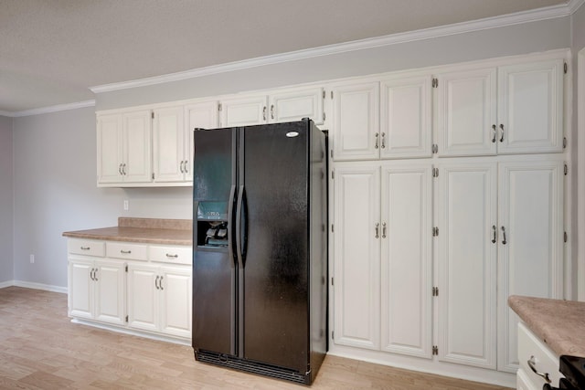 4593 Ashbrook Ct, Martinez, GA 30907 - kitchen featuring black fridge, ornamental molding, light wood-style flooring, and white cabinetry