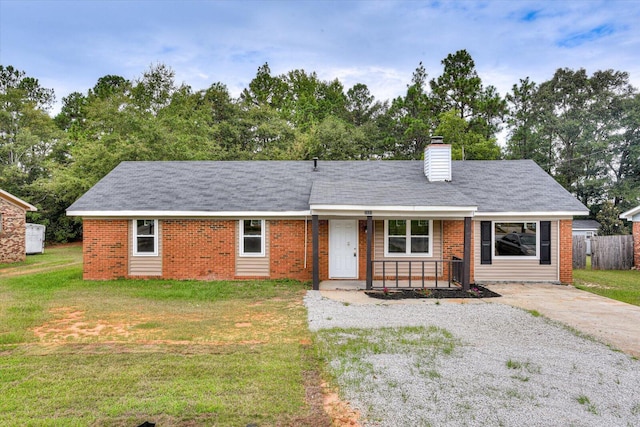 ranch-style home with a front lawn and covered porch