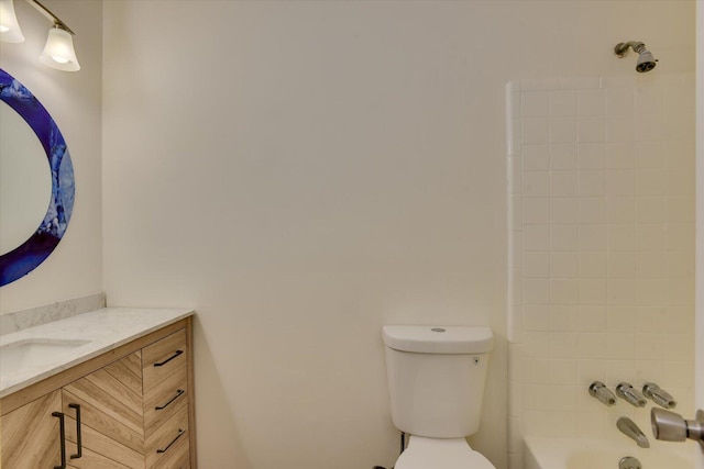 full bathroom featuring vanity, toilet, and tiled shower / bath combo