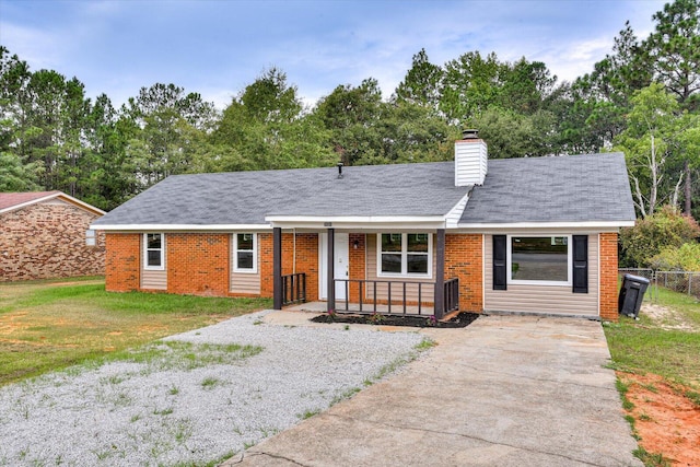 ranch-style house with covered porch and a front lawn