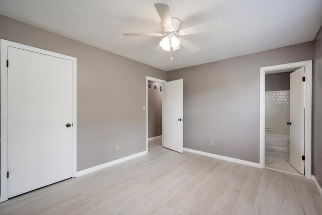2323 Basswood Dr, Augusta, GA 30906 - unfurnished bedroom with light wood-style flooring, baseboards, ensuite bathroom, and a ceiling fan