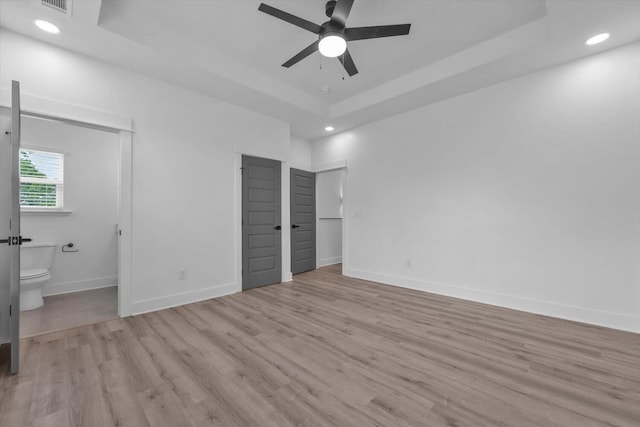 1116 Miller St, Augusta, GA 30901 - unfurnished bedroom with light wood-style floors, recessed lighting, baseboards, connected bathroom, and a raised ceiling