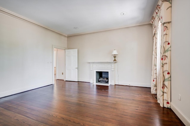 unfurnished living room with ornamental molding, wood finished floors, a fireplace with flush hearth, and baseboards