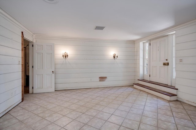 foyer featuring wooden walls